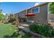 Spacious backyard featuring a concrete patio with furniture and lush green lawn at 1758 Parkdale N Cir, Erie, CO 80516