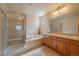 Bright bathroom features a separate shower, soaking tub, double sink, and a large mirror at 1758 Parkdale N Cir, Erie, CO 80516