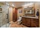 Stylish bathroom features a glass shower, storage cabinet, vanity sink, and modern fixtures at 1758 Parkdale N Cir, Erie, CO 80516