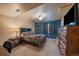 Bedroom features a bed and dresser, with a blue accent wall and carpeted floors at 1758 Parkdale N Cir, Erie, CO 80516