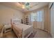 Charming bedroom features a colorful ceiling fan and a window that provides natural light at 1758 Parkdale N Cir, Erie, CO 80516