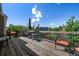 Outdoor deck featuring an umbrella, chairs, and table with backyard views at 1758 Parkdale N Cir, Erie, CO 80516