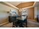 Formal dining room with dark wood table, modern chandelier, and lots of natural light at 1758 Parkdale N Cir, Erie, CO 80516