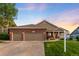 Charming two-story home with a well-manicured lawn, brick accents, a covered porch and attached two car garage at 1758 Parkdale N Cir, Erie, CO 80516