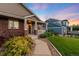 Inviting covered front porch with detailed columns and well-manicured landscaping at 1758 Parkdale N Cir, Erie, CO 80516