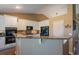 Modern kitchen with granite countertops, stainless steel appliances, and white cabinetry at 1758 Parkdale N Cir, Erie, CO 80516