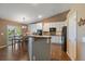 Modern kitchen with granite countertops, stainless steel appliances, and white cabinetry at 1758 Parkdale N Cir, Erie, CO 80516