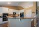 Open kitchen boasts granite countertops, white cabinetry, and modern black appliances at 1758 Parkdale N Cir, Erie, CO 80516