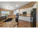 Modern kitchen with granite countertops, stainless steel appliances, and white cabinetry at 1758 Parkdale N Cir, Erie, CO 80516