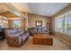 Comfortable living room featuring vaulted ceilings, neutral tones, and ample natural light at 1758 Parkdale N Cir, Erie, CO 80516