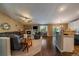 Open-concept living room with fireplace, built-ins, plush seating, and hardwood floors at 1758 Parkdale N Cir, Erie, CO 80516
