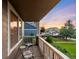 Cozy outdoor porch featuring comfortable seating and a view of the well-maintained lawn at 1758 Parkdale N Cir, Erie, CO 80516