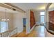 Hallway with exposed brick wall and hardwood floors at 3233 Osage St # 2A, Denver, CO 80211