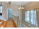 Bright hallway with hardwood floors, chandelier, and staircase at 3233 Osage St # 2A, Denver, CO 80211