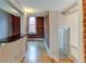 Hallway view with exposed brick and kitchen peek at 3233 Osage St # 2A, Denver, CO 80211