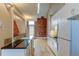 White kitchen with granite counters and exposed brick at 3233 Osage St # 2A, Denver, CO 80211