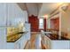 Modern white kitchen with granite countertops and exposed brick at 3233 Osage St # 2A, Denver, CO 80211