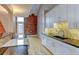 Modern kitchen with white cabinets and granite countertops at 3233 Osage St # 2A, Denver, CO 80211