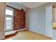 Living area with exposed brick wall and door to balcony at 3233 Osage St # 2A, Denver, CO 80211