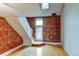 Living room with exposed brick and hardwood floors at 3233 Osage St # 2A, Denver, CO 80211