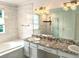 Luxurious bathroom features double vanity, soaking tub, walk-in shower and white marble tiling throughout the bathroom at 15292 E Hialeah Pl, Aurora, CO 80015