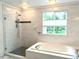 Beautifully renovated bathroom with soaking tub and a glass enclosed walk in shower and a large window at 15292 E Hialeah Pl, Aurora, CO 80015