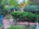 Garden featuring lush green foliage, various plant textures, and ornamental statues at 15292 E Hialeah Pl, Aurora, CO 80015