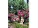 Rose garden featuring angel statue, pink flowers, and mature landscaping at 15292 E Hialeah Pl, Aurora, CO 80015