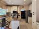 Spacious kitchen with granite countertops, white cabinetry, and stainless steel appliances at 15292 E Hialeah Pl, Aurora, CO 80015