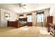 Spacious main bedroom with large bed, carpeted floors, ceiling fan, and bright sunlight coming in from the windows at 15292 E Hialeah Pl, Aurora, CO 80015