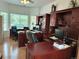 Bright office with multiple desks, built-in cabinets, and a large window at 15292 E Hialeah Pl, Aurora, CO 80015