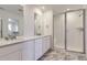 Modern bathroom with double vanity, granite countertops, a glass-enclosed shower, and contemporary finishes at 968 Congress Pl, Elizabeth, CO 80107