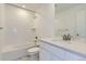 Bright bathroom featuring a soaking tub, white subway tile, modern vanity and a quartz countertop at 968 Congress Pl, Elizabeth, CO 80107