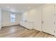 Hallway nook with light-colored hardwood floors, a sink, and white cabinets at 968 Congress Pl, Elizabeth, CO 80107