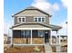 Charming two-story home featuring stone accents, a covered porch, and a well-manicured front yard at 22203 E 6Th Pl, Aurora, CO 80018