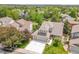 Aerial view of the home featuring a well-manicured lawn, mature trees, and a three-car garage at 20530 Parker Vista Cir, Parker, CO 80138
