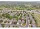 A sprawling neighborhood viewed from above, showcasing tree-lined streets and well-maintained properties at 20530 Parker Vista Cir, Parker, CO 80138