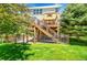 Charming backyard featuring a deck with sunshade and a chain-link fence surrounding the lush green lawn at 20530 Parker Vista Cir, Parker, CO 80138