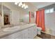 Bathroom featuring dual sinks, white cabinets, and a shower with a bathtub at 20530 Parker Vista Cir, Parker, CO 80138