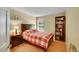 Inviting bedroom featuring wood floors, a bookshelf, and a window providing natural light at 20530 Parker Vista Cir, Parker, CO 80138