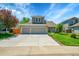 Charming two-story home with a three car garage, manicured lawn, and spacious driveway at 20530 Parker Vista Cir, Parker, CO 80138