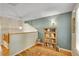 Upstairs hallway featuring hardwood floors, a bookshelf and overhead lighting at 20530 Parker Vista Cir, Parker, CO 80138