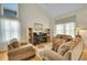 Inviting living room with large windows, hardwood floors, and comfortable seating around a piano at 20530 Parker Vista Cir, Parker, CO 80138