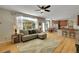 Bright living room featuring a large window, hardwood floors, and a modern ceiling fan at 20530 Parker Vista Cir, Parker, CO 80138
