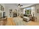 Comfortable living room with a fireplace, built-in bookshelves, and a large window at 20530 Parker Vista Cir, Parker, CO 80138