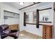 This bedroom offers a comfortable chair, natural light, and wood flooring at 6743 Wild Rose Ln, Evergreen, CO 80439