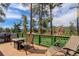 Enjoy the mountain views from this outdoor deck with green railings at 6743 Wild Rose Ln, Evergreen, CO 80439