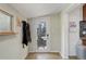 Bright entryway featuring a glass door, coat rack, and wood-look flooring at 6743 Wild Rose Ln, Evergreen, CO 80439