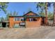Exterior of cozy log cabin showcasing its design and the surrounding natural landscape at 6743 Wild Rose Ln, Evergreen, CO 80439