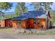 The exterior of this home features log siding and mountain views at 6743 Wild Rose Ln, Evergreen, CO 80439